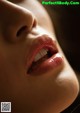 A close up of a woman's mouth with her tongue out.